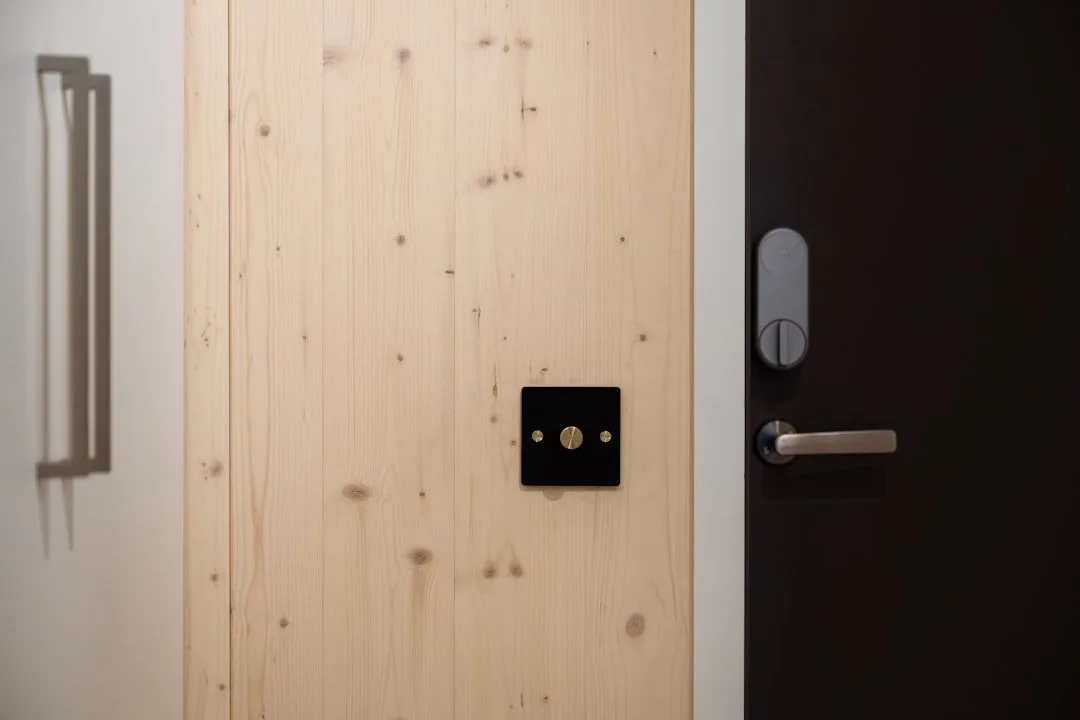 Smart door and window sensor mounted on a white door frame
