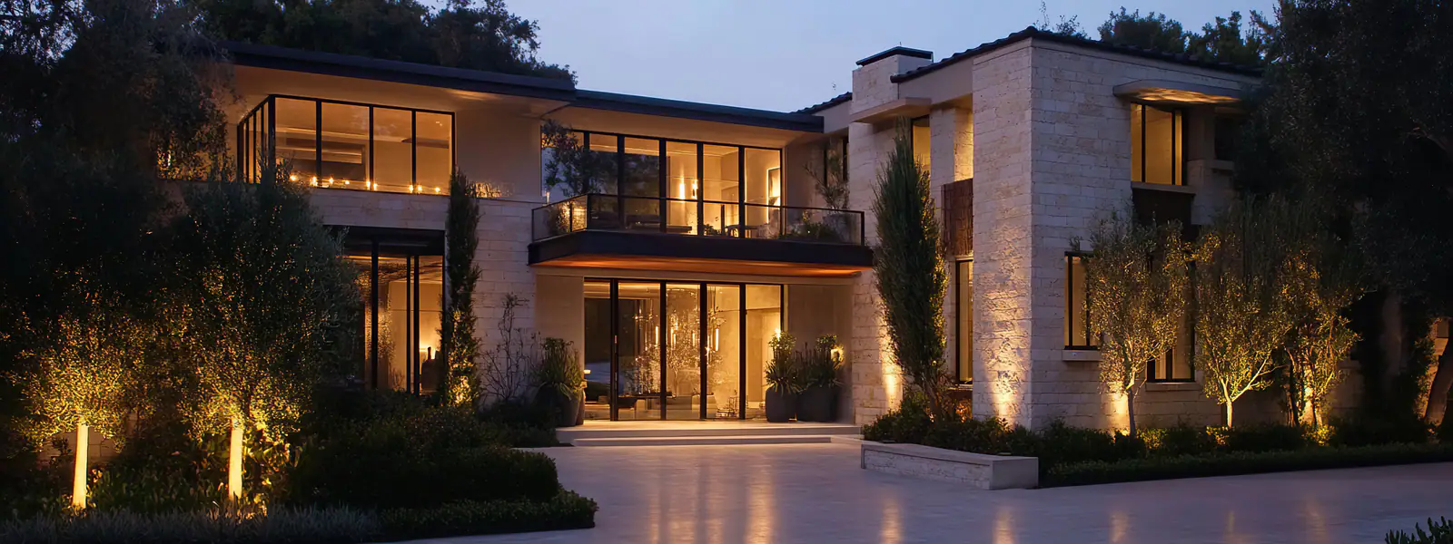 Limestone estate with architectural uplighting at dusk