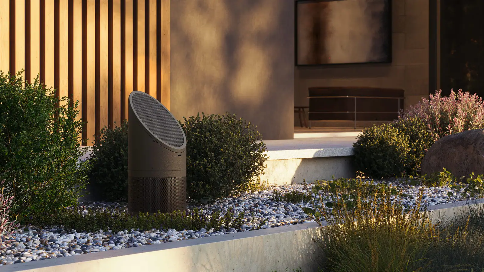A sculptural landscape speaker set among planting in a modern garden