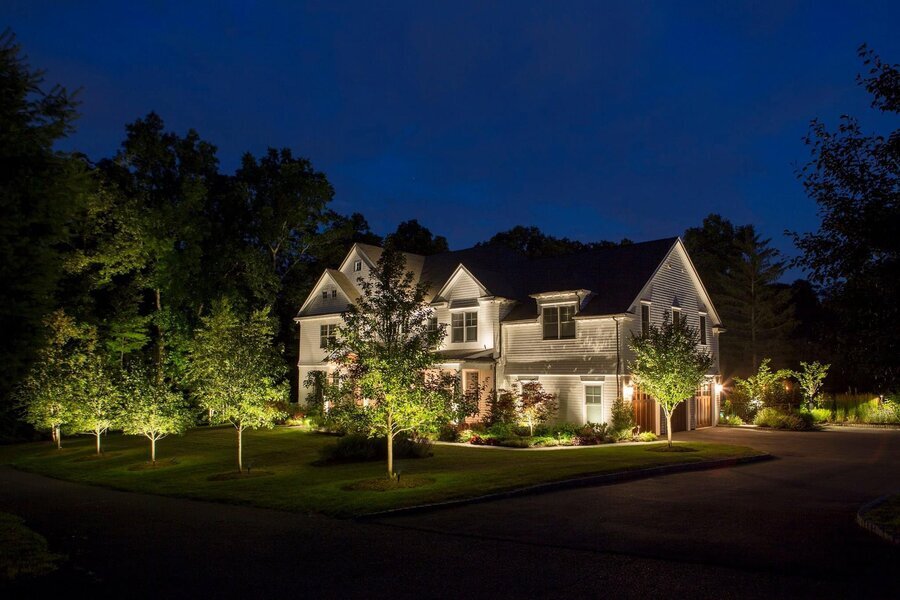 A home and its surroundings are illuminated with Coastal Source landscape lighting solutions.